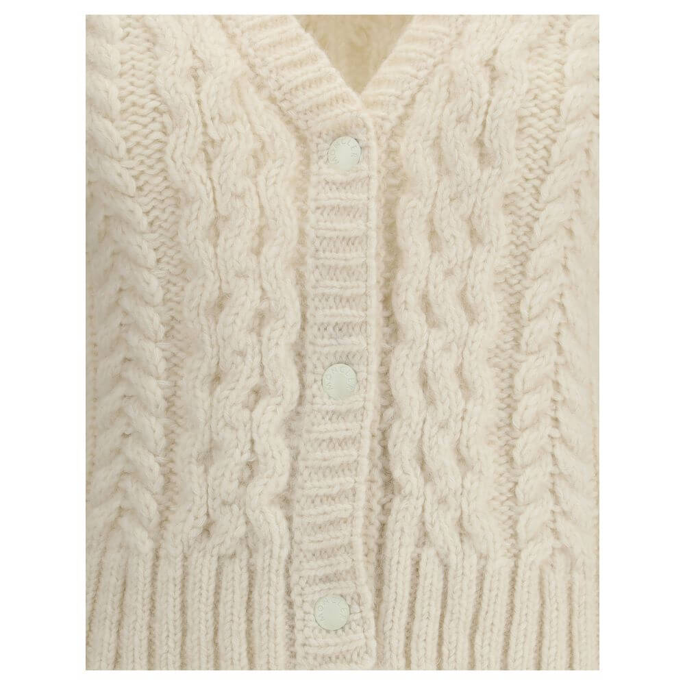 Cream Alpaca Vicugna Pacos CardiganThe V-neck cardigan by Moncler is reimagined with a contemporary twist through refined textures. Crafted from a luxurious blend of nylon, wool, alpaca, and mohair, it features a distinctive cable and Aran knit that adds
