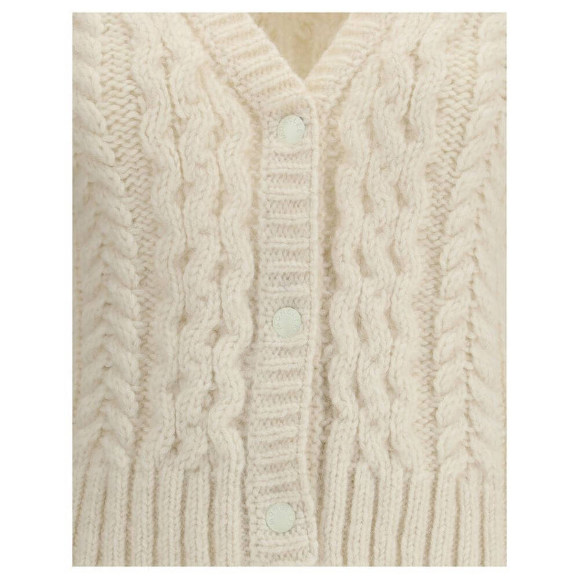 Cream Alpaca Vicugna Pacos CardiganThe V-neck cardigan by Moncler is reimagined with a contemporary twist through refined textures. Crafted from a luxurious blend of nylon, wool, alpaca, and mohair, it features a distinctive cable and Aran knit that adds