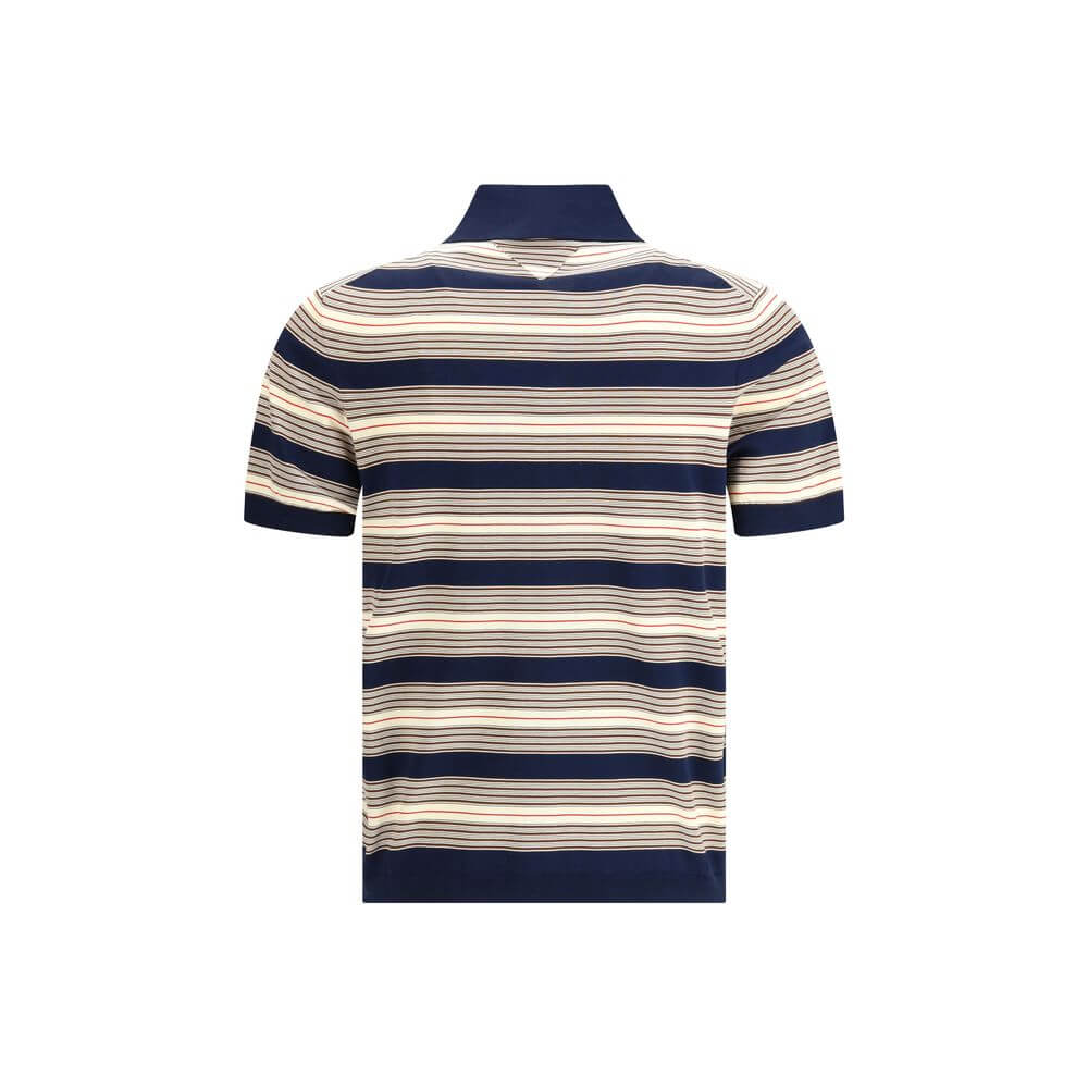 Multicolor Cotton Polo ShirtThe striped cotton Polo by Prada reimagines a menswear classic through the lens of the Maison’s refined aesthetic. Knitted from stretch cotton, it balances comfort and clean lines, enriched with solid-color details that highlig