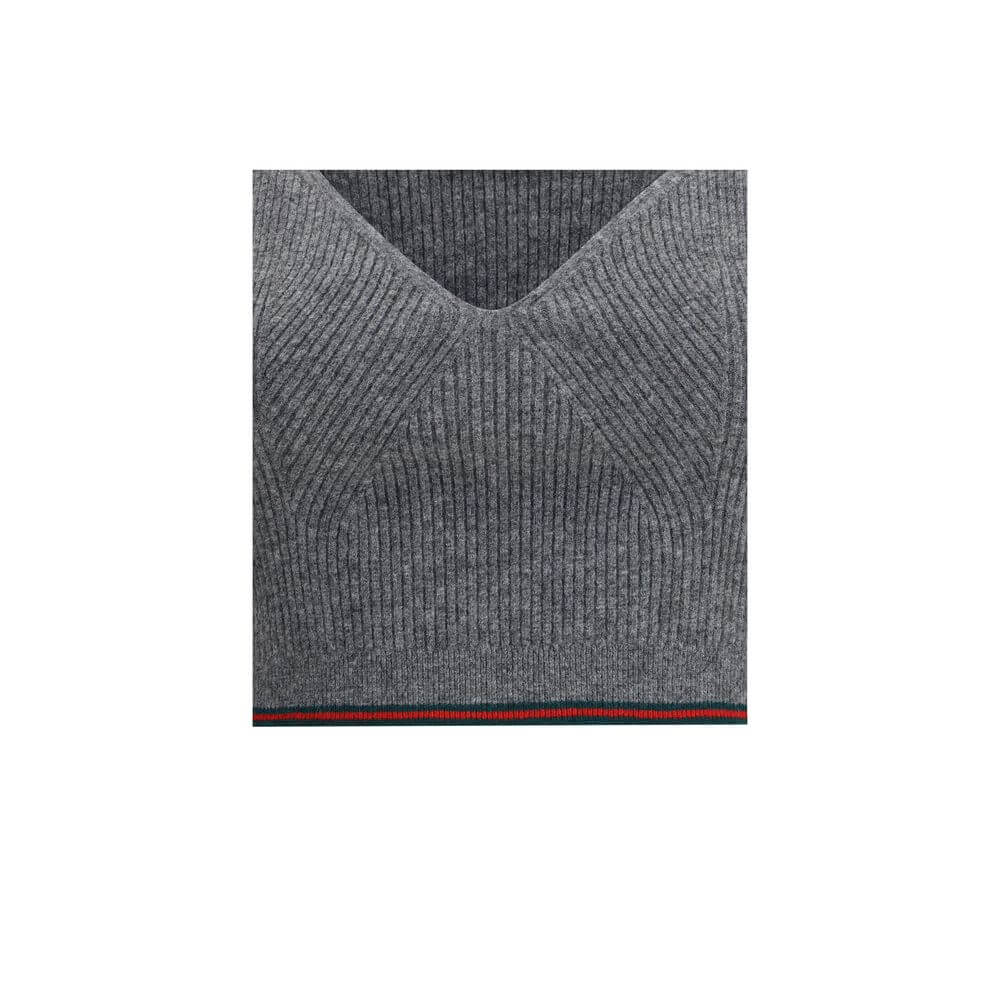 Gray Wool TopThe V-neck ribbed Top by Gucci elevates the simplicity of ribbed knitwear with the narrative power of the maison’s signature green and red Web trim. Essential lines meet iconic detailing, turning a wardrobe staple into an unmistakable style s