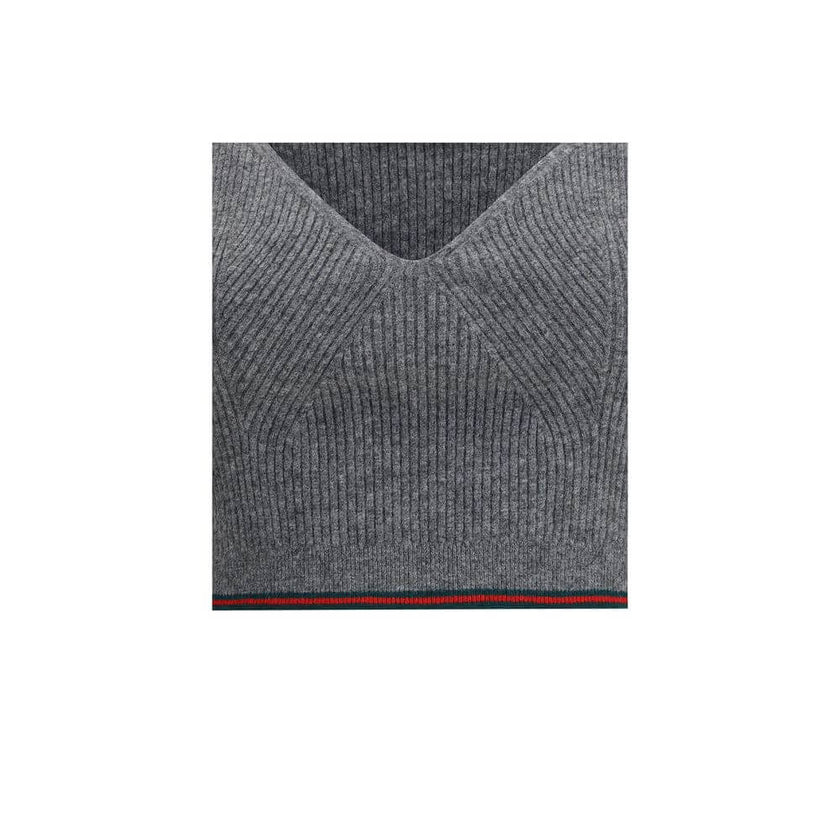 Gray Wool TopThe V-neck ribbed Top by Gucci elevates the simplicity of ribbed knitwear with the narrative power of the maison’s signature green and red Web trim. Essential lines meet iconic detailing, turning a wardrobe staple into an unmistakable style s