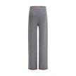 Gray Wool Casual PantsThe ribbed Wool Trousers by Gucci highlight the House’s signature codes with the green and red Web trim accenting the waistband and hem. Cut with a wide leg for a relaxed yet refined silhouette, the trousers feature an elasticated wa