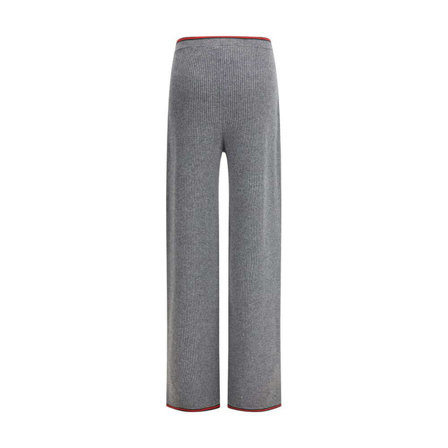 Gray Wool Casual PantsThe ribbed Wool Trousers by Gucci highlight the House’s signature codes with the green and red Web trim accenting the waistband and hem. Cut with a wide leg for a relaxed yet refined silhouette, the trousers feature an elasticated wa