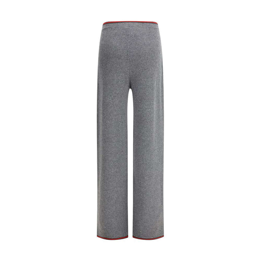 Gray Wool Casual PantsThe ribbed Wool Trousers by Gucci highlight the House’s signature codes with the green and red Web trim accenting the waistband and hem. Cut with a wide leg for a relaxed yet refined silhouette, the trousers feature an elasticated wa