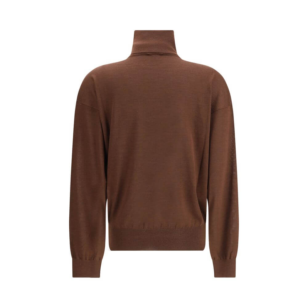 Brown Cashmere TurtleneckThe Turtleneck Pullover in Cashmere, Wool, and Silk by Saint Laurent is a refined and enveloping piece that combines comfort with understated luxury. Designed with a relaxed fit and dropped shoulders, it features ribbed finishes t
