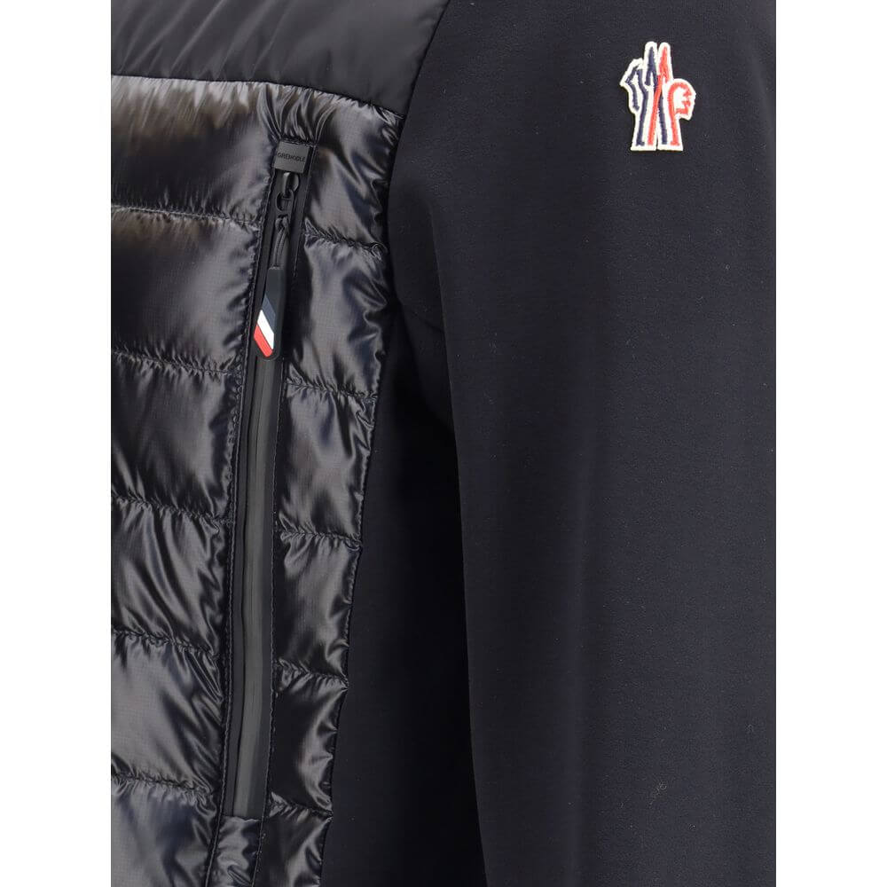 Black Polyester Shell JacketThe padded Polartec® zip-up Jacket by Moncler Grenoble designed for superior comfort and performance in outdoor and mountain settings. Crafted with down-feather filling and a quilted structure, it ensures warmth and lightness.