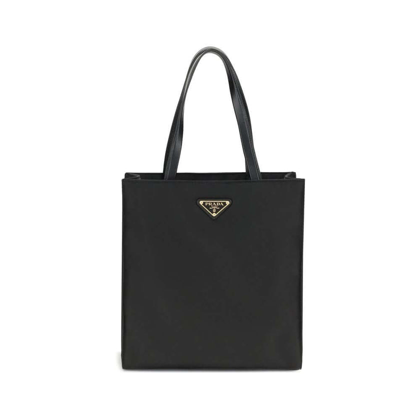 Black Recycled Polyamide Shoulder BagRe-Nylon Tote Bag by Prada features a functional and elegant design. Equipped with two leather handles, it features the iconic triangular plaque on the front and an adjustable and removable nylon shoulder strap for add
