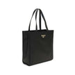 Black Recycled Polyamide Shoulder BagRe-Nylon Tote Bag by Prada features a functional and elegant design. Equipped with two leather handles, it features the iconic triangular plaque on the front and an adjustable and removable nylon shoulder strap for add