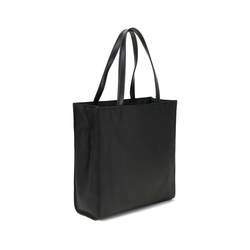 Black Recycled Polyamide Shoulder BagRe-Nylon Tote Bag by Prada features a functional and elegant design. Equipped with two leather handles, it features the iconic triangular plaque on the front and an adjustable and removable nylon shoulder strap for add