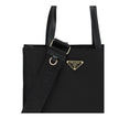 Black Recycled Polyamide Shoulder BagRe-Nylon Tote Bag by Prada features a functional and elegant design. Equipped with two leather handles, it features the iconic triangular plaque on the front and an adjustable and removable nylon shoulder strap for add