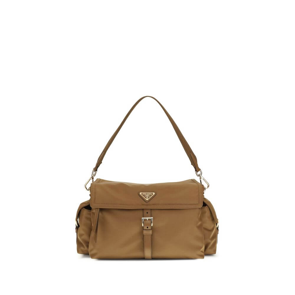Brown Recycled Polyamide Shoulder BagExplore large Shoulder Bag by Prada is made of Re-Nylon and features a flap with a classic enameled metal triangle logo. It features a padded ribbon handle, front zipper pocket, side flap pockets, and metal trim. The c