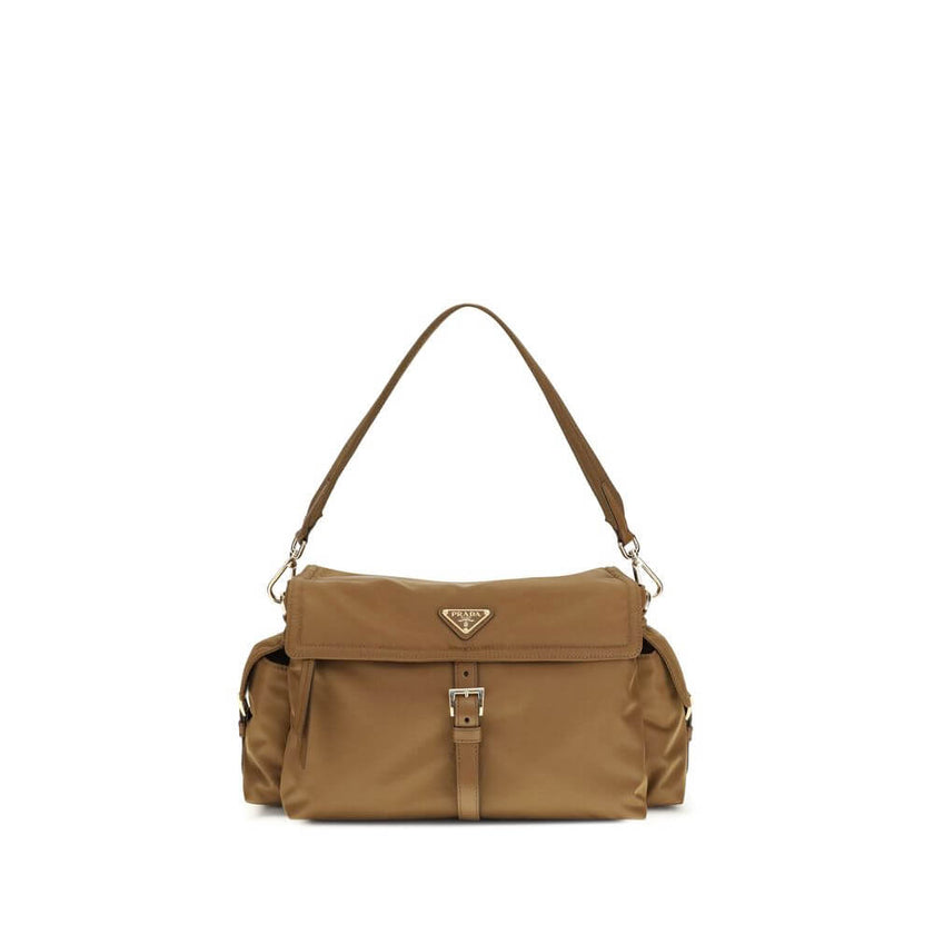 Brown Recycled Polyamide Shoulder BagExplore large Shoulder Bag by Prada is made of Re-Nylon and features a flap with a classic enameled metal triangle logo. It features a padded ribbon handle, front zipper pocket, side flap pockets, and metal trim. The c