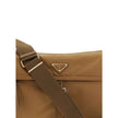 Brown Recycled Polyamide Shoulder BagExplore large Shoulder Bag by Prada is made of Re-Nylon and features a flap with a classic enameled metal triangle logo. It features a padded ribbon handle, front zipper pocket, side flap pockets, and metal trim. The c