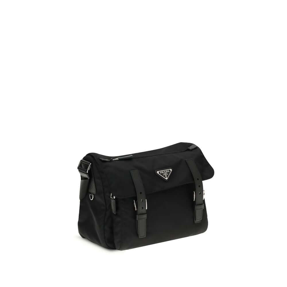 Black Polyamide Shoulder BagExplore medium Shoulder Bag by Prada is made of Re-Nylon and finished with metal details. It features a front zippered pocket, enameled triangle logo flap, and zipper and strap closure. The interior, also made of Re-Nylon, incl