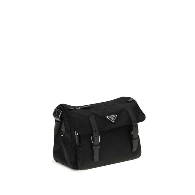 Black Polyamide Shoulder BagExplore medium Shoulder Bag by Prada is made of Re-Nylon and finished with metal details. It features a front zippered pocket, enameled triangle logo flap, and zipper and strap closure. The interior, also made of Re-Nylon, incl
