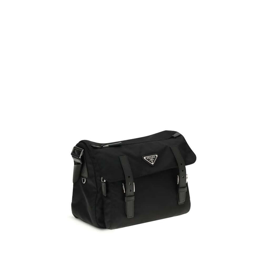 Black Polyamide Shoulder BagExplore medium Shoulder Bag by Prada is made of Re-Nylon and finished with metal details. It features a front zippered pocket, enameled triangle logo flap, and zipper and strap closure. The interior, also made of Re-Nylon, incl