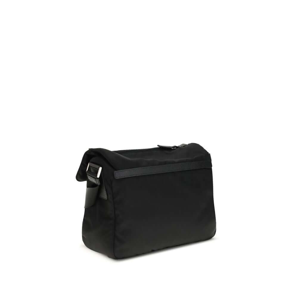Black Polyamide Shoulder BagExplore medium Shoulder Bag by Prada is made of Re-Nylon and finished with metal details. It features a front zippered pocket, enameled triangle logo flap, and zipper and strap closure. The interior, also made of Re-Nylon, incl