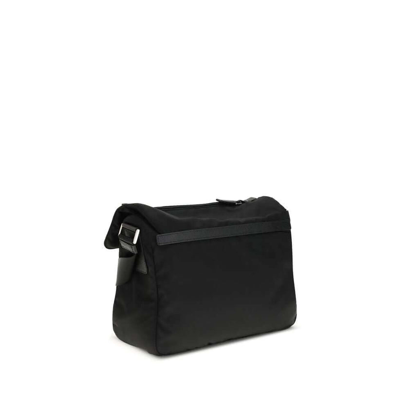 Black Polyamide Shoulder BagExplore medium Shoulder Bag by Prada is made of Re-Nylon and finished with metal details. It features a front zippered pocket, enameled triangle logo flap, and zipper and strap closure. The interior, also made of Re-Nylon, incl
