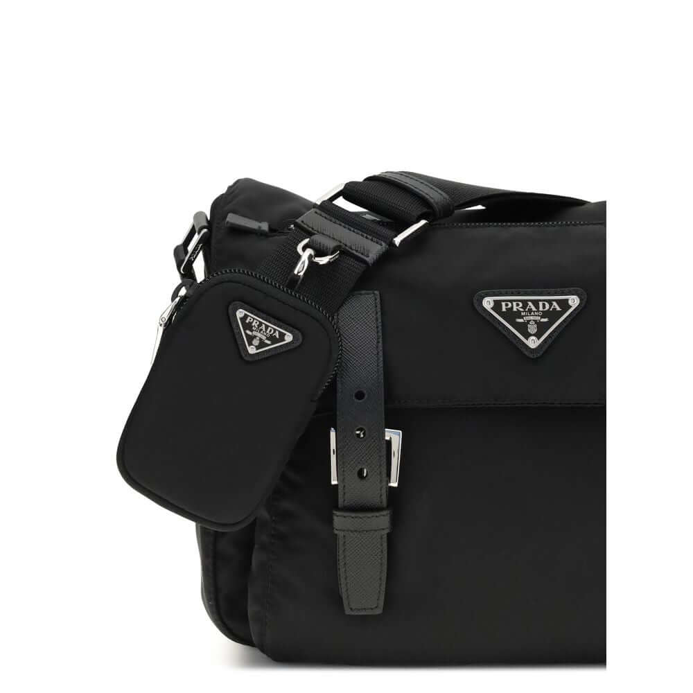 Black Polyamide Shoulder BagExplore medium Shoulder Bag by Prada is made of Re-Nylon and finished with metal details. It features a front zippered pocket, enameled triangle logo flap, and zipper and strap closure. The interior, also made of Re-Nylon, incl