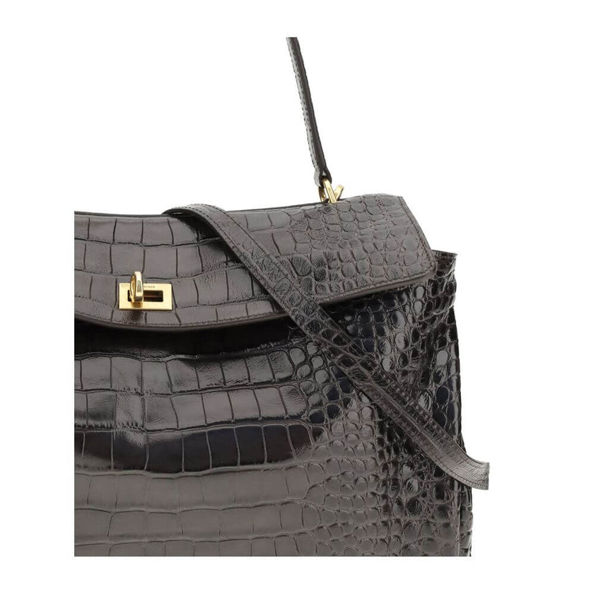 Brown Calf Leather Bos Taurus HandbagLeather Medium Rodeo Handbag by Balenciaga, single removable top handle, charm with key ring detail applied at base of handle, dual compartment, flap closure with swivel system at front, crocodile-effect leather design
