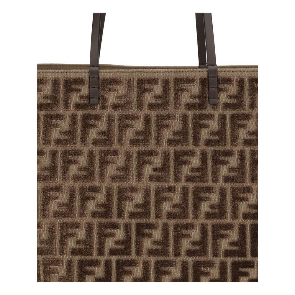 Brown Fabric Shoulder BagTote Bag by Fendi is made with the iconic FF all-over printed chenille pattern, creating a luxurious and sophisticated effect. Featuring two flat leather handles, this bag combines practicality and elegance. The interior features