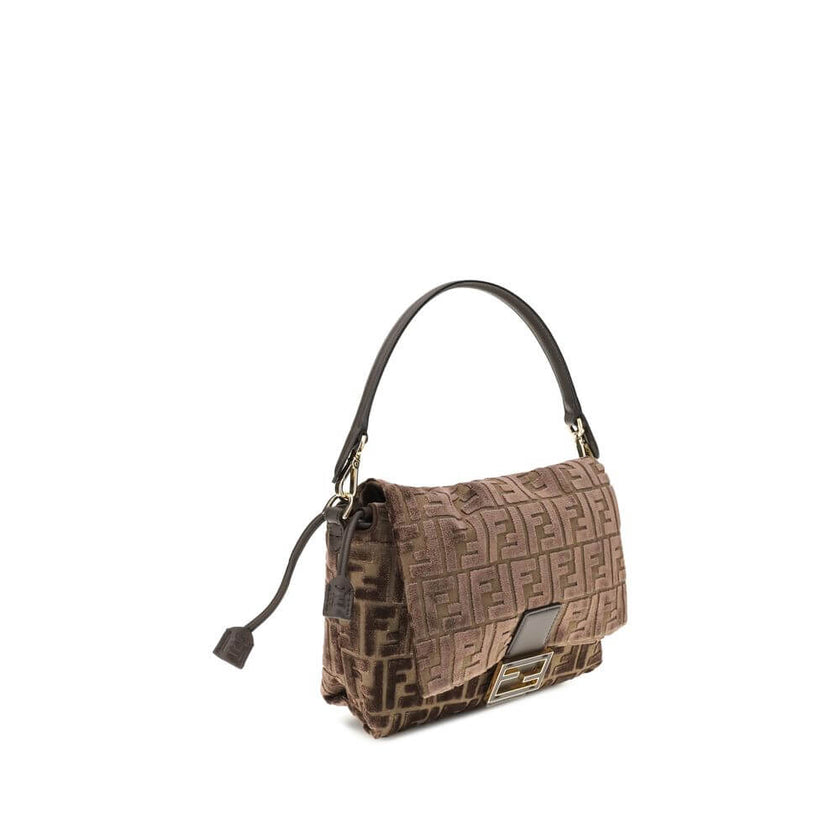 Brown Viscose Shoulder BagMedium Mamma Baguette Shoulder Bag by Fendi is made of jacquard velvet with a dark brown embossed FF pattern on a brown base. It is decorated with an FF closure with tone-on-tone leather insert and features a front flap with magn