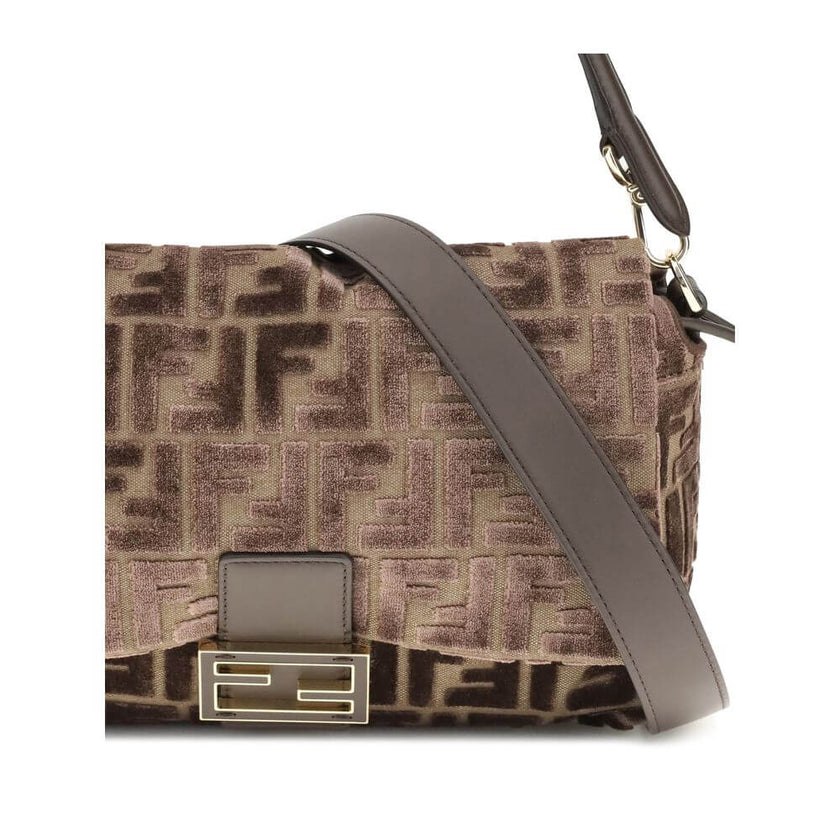 Brown Viscose Shoulder BagMedium Mamma Baguette Shoulder Bag by Fendi is made of jacquard velvet with a dark brown embossed FF pattern on a brown base. It is decorated with an FF closure with tone-on-tone leather insert and features a front flap with magn