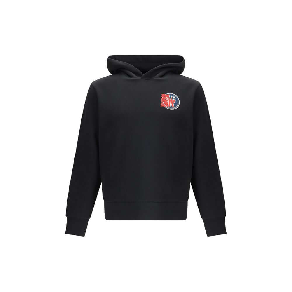 Black Cotton SweatshirtThe cotton hooded Sweatshirt by Moncler is a timeless casual essential reimagined with a distinctive touch. Crafted from soft cotton jersey, it features an adjustable hood, ribbed trims, and the iconic star-shaped logo patch on the