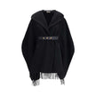 Wool CapeThe wool Cape by Moncler, defined by an elegant draped design that makes it a versatile layering piece for every season. Crafted from soft wool with light padding, it features a nylon laqué belt to define the silhouette, fringed edges, and the ic