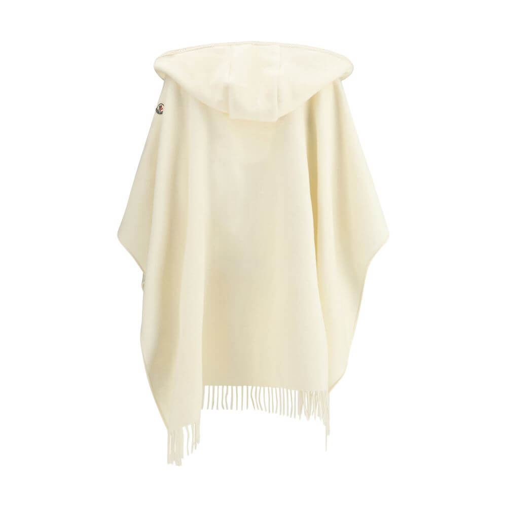 Cream Fleece Wool CoatThe wool Cape by Moncler, defined by an elegant draped design that makes it a versatile layering piece for every season. Crafted from soft wool with light padding, it features a nylon laqué belt to define the silhouette, fringed edge