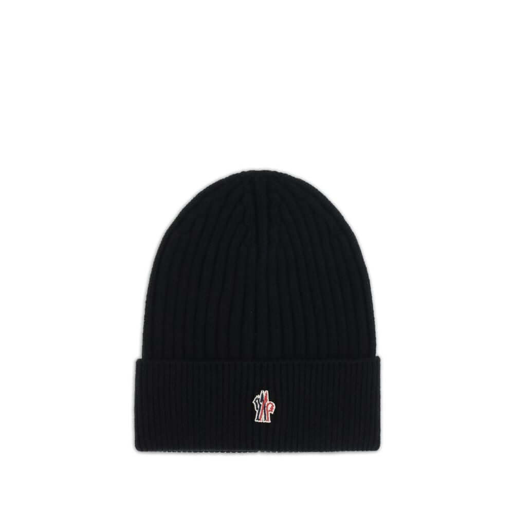 Black Fleece Wool BeanieBeanie Hat by Moncler Grenoble combines functionality and style in an essential cold-weather accessory. Made with ribbed fabrication, it offers a snug and comfortable fit. The Moncler Grenoble logo sewn on the front adds a distinct