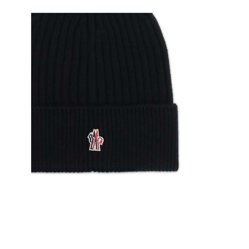 Black Fleece Wool BeanieBeanie Hat by Moncler Grenoble combines functionality and style in an essential cold-weather accessory. Made with ribbed fabrication, it offers a snug and comfortable fit. The Moncler Grenoble logo sewn on the front adds a distinct