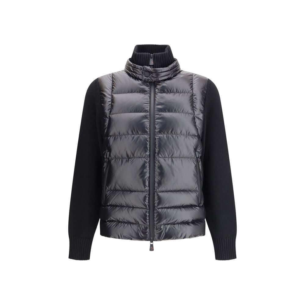 Panelled JacketThe panelled Jacket by Moncler Grenoble crafted from a wool blend, featuring a down-feather padded design that alternates quilted sections with knitted panels. It comes with a high neck, front zip fastening, long sleeves, and ribbed cuffs a