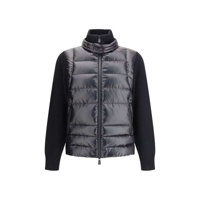 Panelled JacketThe panelled Jacket by Moncler Grenoble crafted from a wool blend, featuring a down-feather padded design that alternates quilted sections with knitted panels. It comes with a high neck, front zip fastening, long sleeves, and ribbed cuffs a