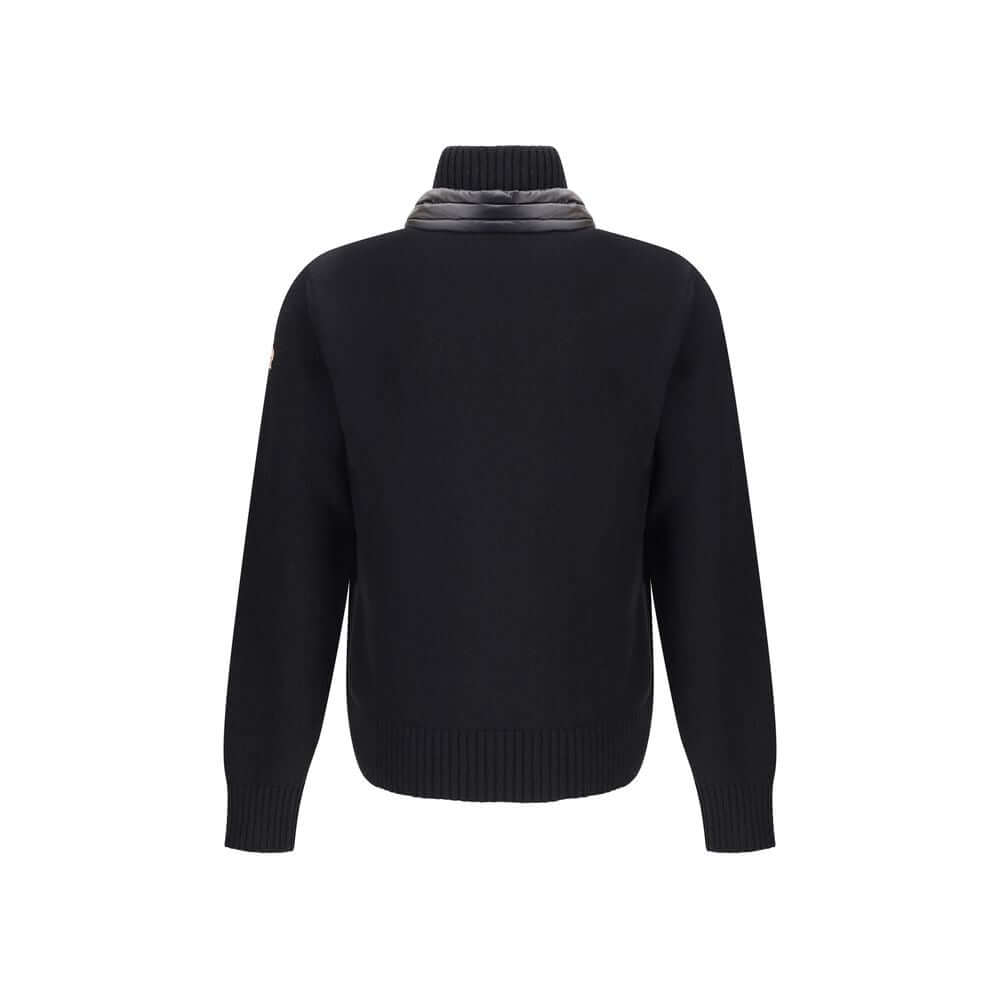 Panelled JacketThe panelled Jacket by Moncler Grenoble crafted from a wool blend, featuring a down-feather padded design that alternates quilted sections with knitted panels. It comes with a high neck, front zip fastening, long sleeves, and ribbed cuffs a