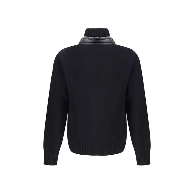 Panelled JacketThe panelled Jacket by Moncler Grenoble crafted from a wool blend, featuring a down-feather padded design that alternates quilted sections with knitted panels. It comes with a high neck, front zip fastening, long sleeves, and ribbed cuffs a