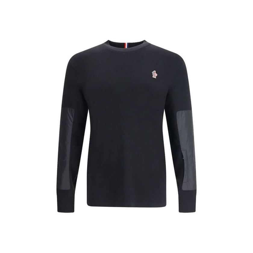 Black Polyamide SweatshirtThe panelled Sweater by Moncler Grenoble combines technical performance with refined craftsmanship. Made from a soft wool blend with padded inserts, it features a knitted construction enhanced by contrasting technical panels that
