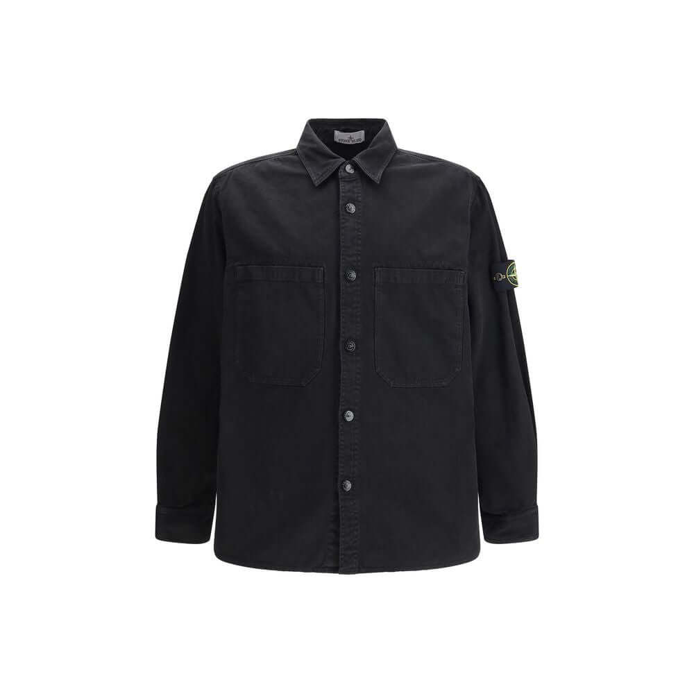 Black Cotton ShirtThe Stone Island Overshirt, crafted from 100% black cotton, is a versatile essential that blends functionality with contemporary style. Featuring a button fastening, two chest patch pockets, and the iconic logo patch on the left sleeve,