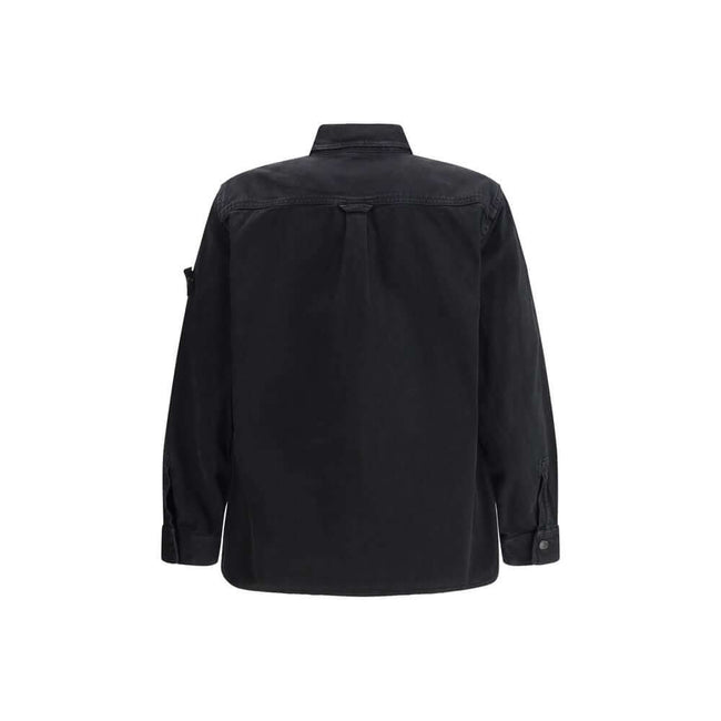 Black Cotton ShirtThe Stone Island Overshirt, crafted from 100% black cotton, is a versatile essential that blends functionality with contemporary style. Featuring a button fastening, two chest patch pockets, and the iconic logo patch on the left sleeve,