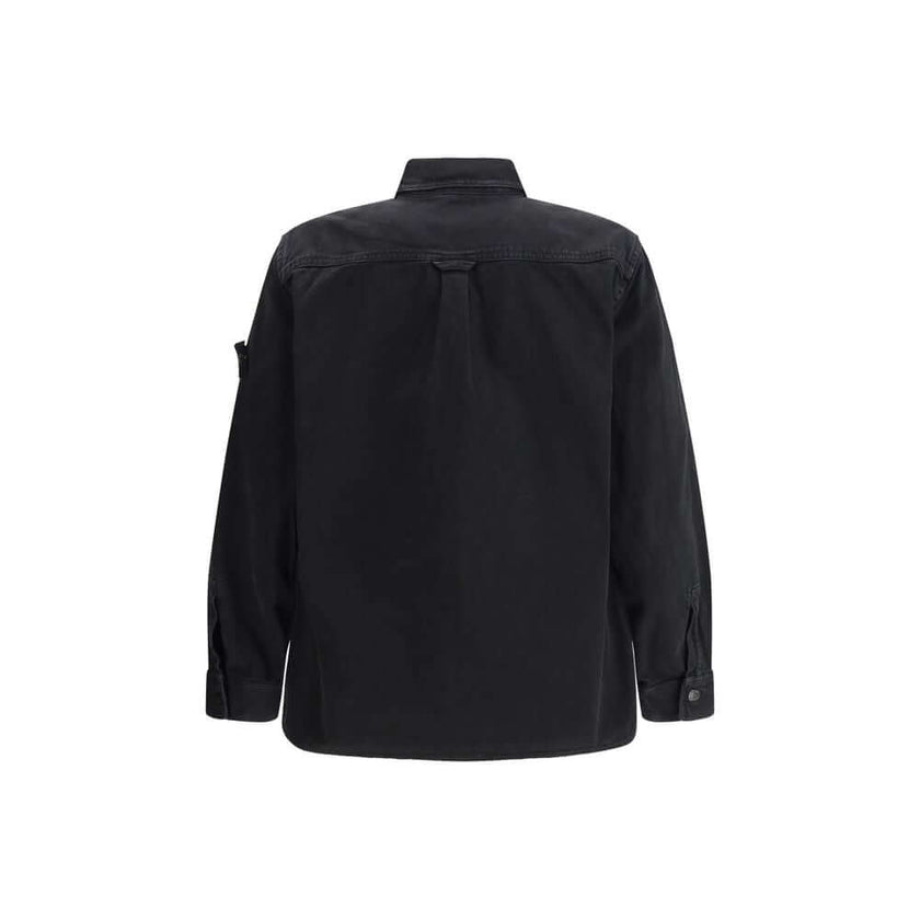 Black Cotton ShirtThe Stone Island Overshirt, crafted from 100% black cotton, is a versatile essential that blends functionality with contemporary style. Featuring a button fastening, two chest patch pockets, and the iconic logo patch on the left sleeve,