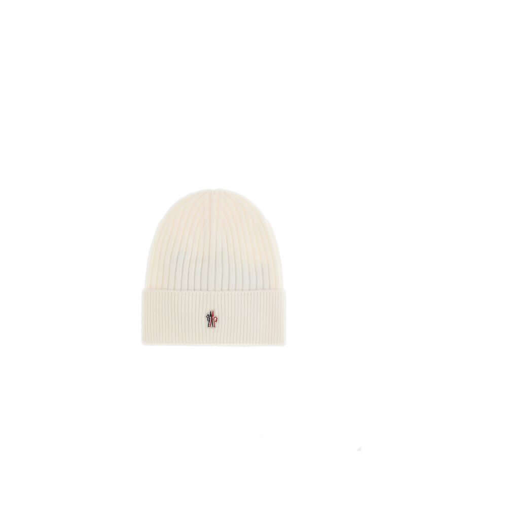 Cream Fleece Wool BeanieBeanie Hat by Moncler Grenoble combines functionality and style in an essential cold-weather accessory. Made with ribbed fabrication, it offers a snug and comfortable fit. The Moncler Grenoble logo sewn on the front adds a distinct