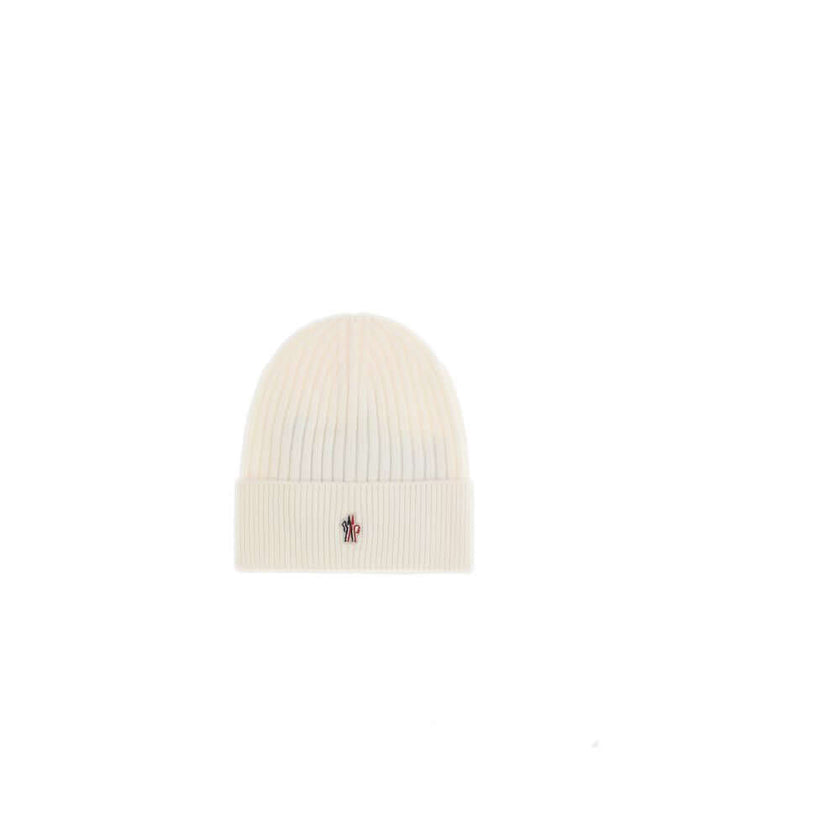 Cream Fleece Wool BeanieBeanie Hat by Moncler Grenoble combines functionality and style in an essential cold-weather accessory. Made with ribbed fabrication, it offers a snug and comfortable fit. The Moncler Grenoble logo sewn on the front adds a distinct