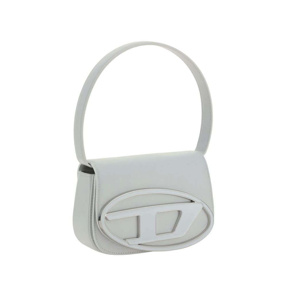 White Calf Leather Bos Taurus Shoulder BagThe 1DR Shoulder Bag by Diesel is made of mirrored leather with a flat shoulder strap. It has a front magnetic closure and the brand’s embossed Oval-D logo. Inside is a welt pocket to keep items in order. A modern