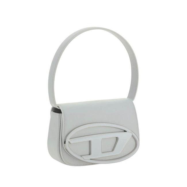 White Calf Leather Bos Taurus Shoulder BagThe 1DR Shoulder Bag by Diesel is made of mirrored leather with a flat shoulder strap. It has a front magnetic closure and the brand’s embossed Oval-D logo. Inside is a welt pocket to keep items in order. A modern