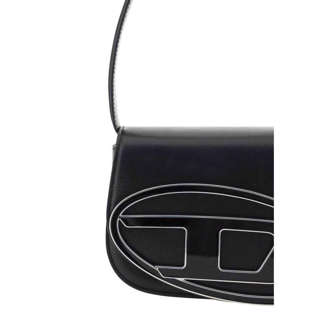 Black Calf Leather Bos Taurus Shoulder BagThe 1DR Shoulder Bag by Diesel is made of mirrored leather with a flat shoulder strap. It has a front magnetic closure and the brand’s embossed Oval-D logo. Inside is a welt pocket to keep items in order. A modern