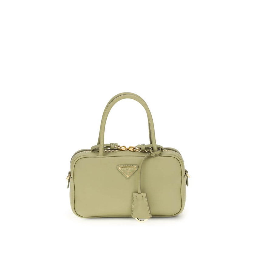 Green Calf Leather Bos Taurus HandbagThe Handbag by Prada combines elegance and functionality in an iconic design. Featuring two tubular handles and a zip closure, it is embellished with a triangular logo plaque on the front, the brand’s distinctive symbo