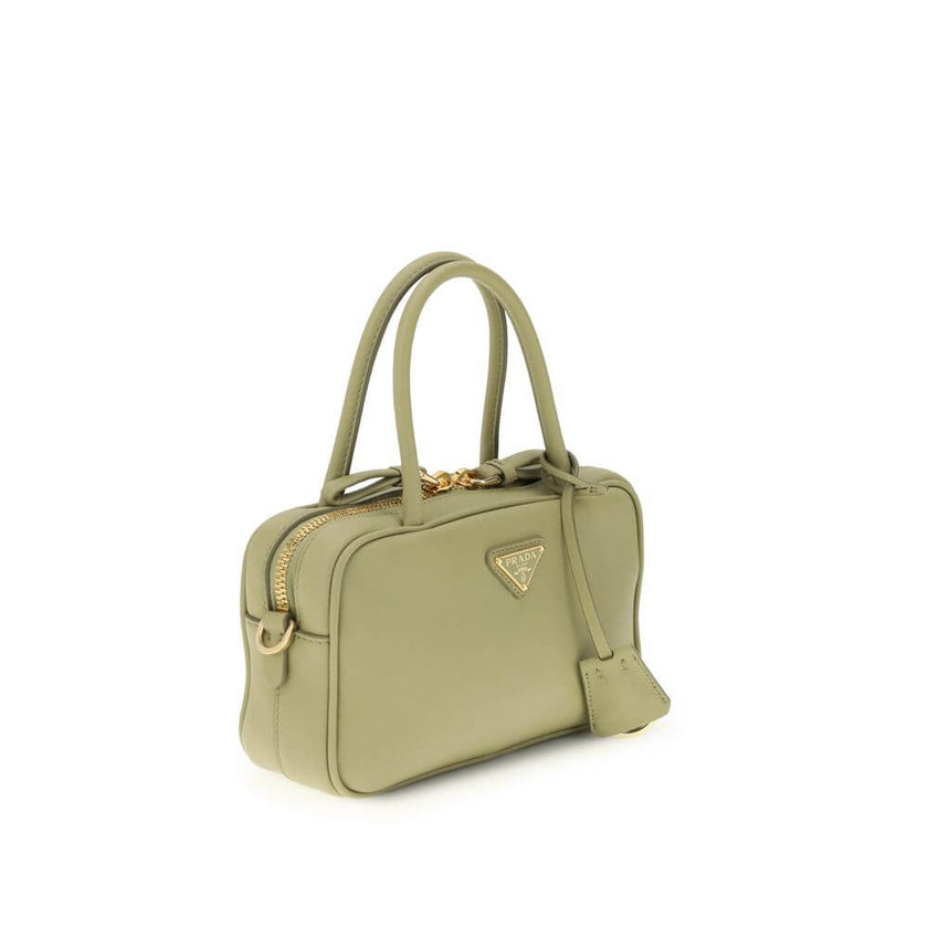 Green Calf Leather Bos Taurus HandbagThe Handbag by Prada combines elegance and functionality in an iconic design. Featuring two tubular handles and a zip closure, it is embellished with a triangular logo plaque on the front, the brand’s distinctive symbo