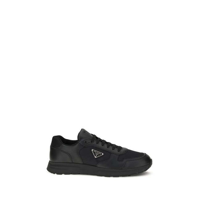 Black Recycled Polyamide Athletic SneakersSneakers by Prada, made of Re-Nylon and brushed leather, combine contemporary style and innovative materials. Equipped with laces, they feature an enameled triangle logo on the upper and screen-printed Prada Milan
