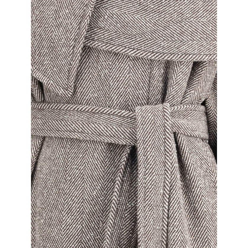 Brown Fleece Wool CoatThe oversized asymmetric Coat by Ferragamo embodies generous proportions and a soft chevron-textured bouclé fabric, offering a refined yet cozy allure. The couture-inspired cuts and fluid lines highlight the brand’s masterful tailori