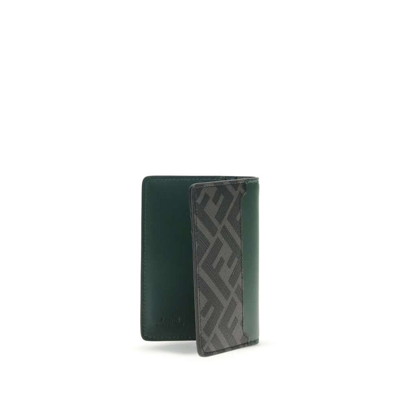 Black Calf Leather Bos Taurus WalletLeather Card Holder by Fendi is a compact and refined accessory, offered in a billfold model. The front features a three-dimensional plaque with the iconic FF logo, the distinctive symbol of the maison. The interior is